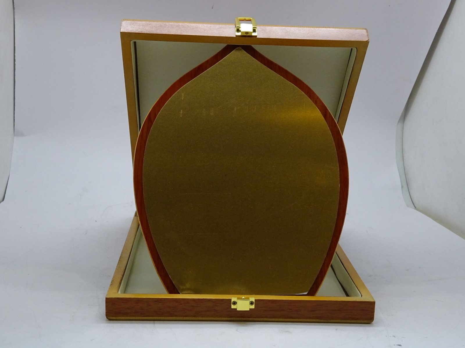 درع معدني ذهبي على خشب